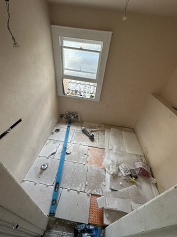 Stone tiles being laid on a decoupling membrane