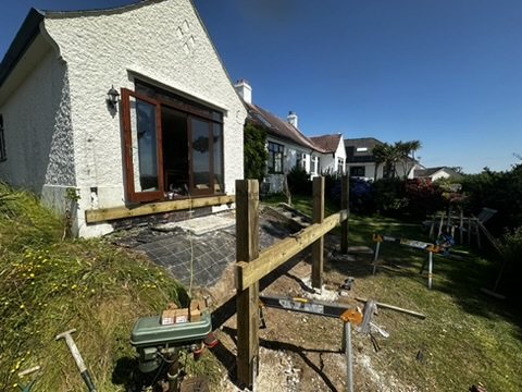 First posts standing beside the house