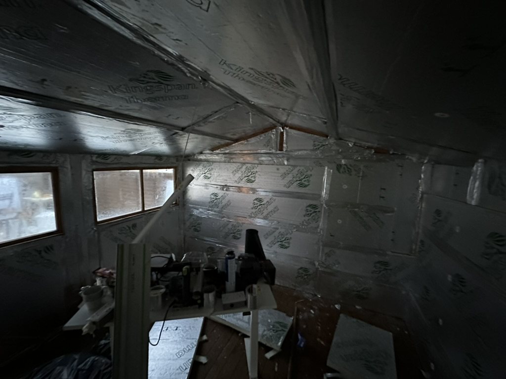 Timber outbuilding insulated and foil-taped