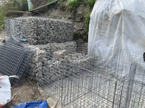 Gabion baskets being filled in tiers
