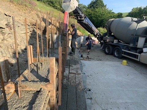 Concrete being poured into shuttering from a mixer truck