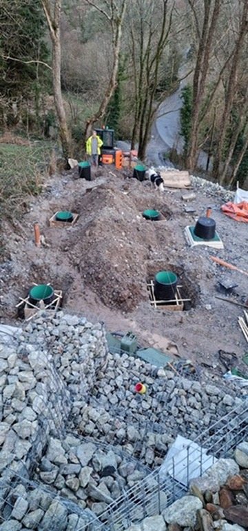 Rows of pier foundations set out across the plot