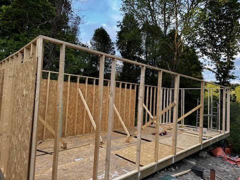 Timber wall frames standing on the floor deck