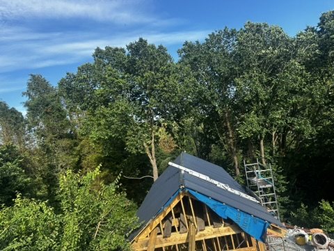 Roof structure up with membrane and metal sheets going on