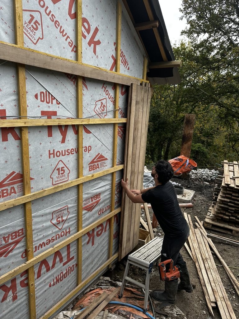 Timber cladding being fixed over battens and breather membrane
