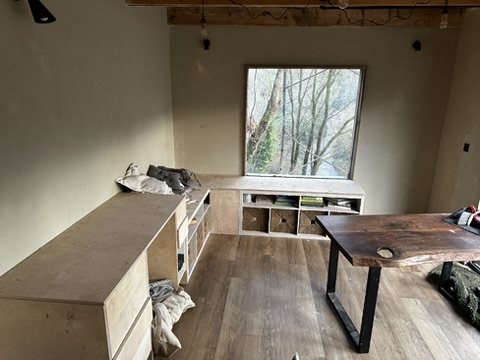 Fitted plywood storage and a live-edge desk